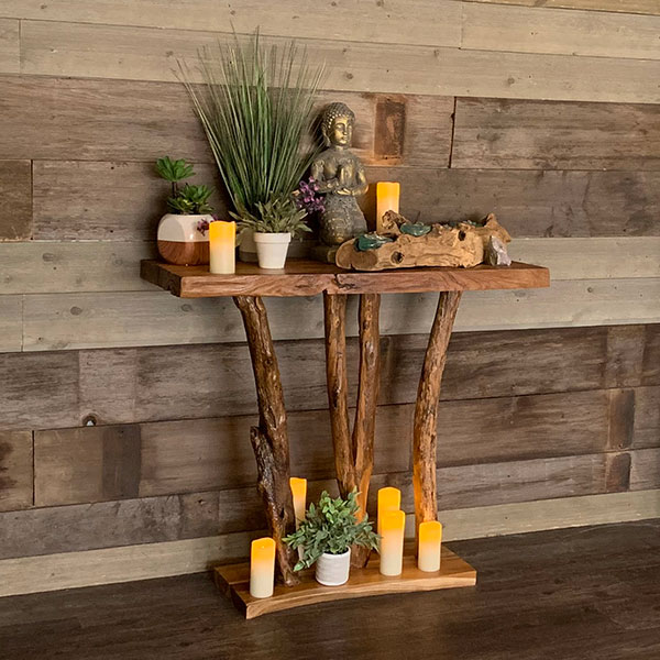 buddha with candles on altar with plants